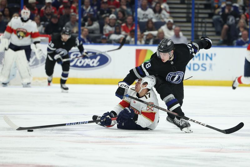 Feb 17, 2024; Tampa, Florida, USA;  Florida Panthers center Evan Rodrigues (17) and Tampa Bay Lightning defenseman Emil Martinsen Lilleberg (78) battle for the puck in the second period at Amalie Arena. Mandatory Credit: Nathan Ray Seebeck-USA TODAY Sports