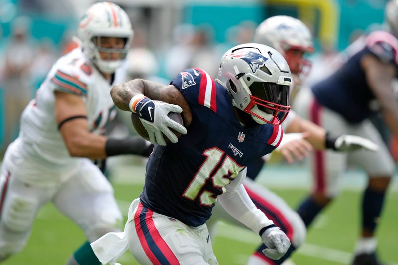 New England Patriots running back Ezekiel Elliott (15) runs during the first half of an NFL football game against the Miami Dolphins, Sunday, Oct. 29, 2023, in Miami Gardens, Fla. (AP Photo/Lynne Sladky)