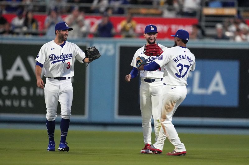 Jun 14, 2024; Los Angeles, California, USA; Los Angeles Dodgers left fielder Chris Taylor (3), center fielder Andy Pages (44) and right fielder Teoscar Herandez (37) celebrate after the game against the Kansas City Royals at Dodger Stadium. Mandatory Credit: Kirby Lee-USA TODAY Sports
