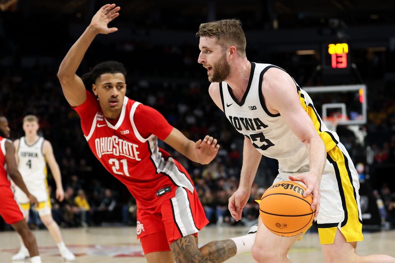 Mar 14, 2024; Minneapolis, MN, USA; Iowa Hawkeyes forward Ben Krikke (23) dribbles around Ohio State Buckeyes forward Devin Royal (21) during the first half at Target Center. Mandatory Credit: Matt Krohn-USA TODAY Sports