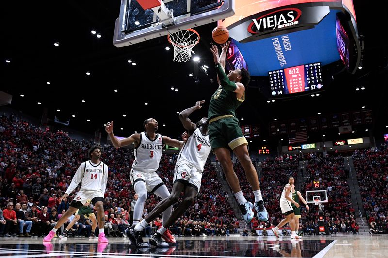 Feb 13, 2024; San Diego, California, USA; Colorado State Rams guard Josiah Strong (3) goes to the basket over San Diego State Aztecs forward Jay Pal (4) during the second half at Viejas Arena. Mandatory Credit: Orlando Ramirez-USA TODAY Sports