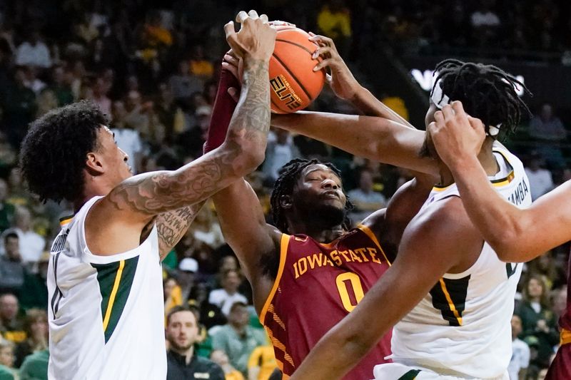 Mar 4, 2023; Waco, Texas, USA; Iowa State Cyclones forward Tre King (0) battles for the ball against Baylor Bears forward Jalen Bridges (11) and forward Flo Thamba (0) during the second half at Ferrell Center. Mandatory Credit: Raymond Carlin III-USA TODAY Sports