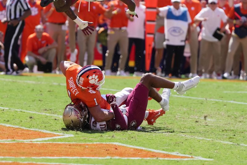 Sep 23, 2023; Clemson, South Carolina, USA; Clemson Tigers running back Will Shipley (1) is tackled in the end zone by Florida State Seminoles defensive back Azareye'h Thomas (20) in the first half at Memorial Stadium. Mandatory Credit: David Yeazell-USA TODAY Sports