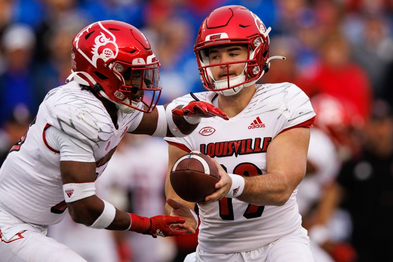 Nov 26, 2022; Lexington, Kentucky, USA; Louisville Cardinals quarterback Brock Domann (19) hands the ball off to Louisville Cardinals running back Jawhar Jordan (25) during the second quarter against the Kentucky Wildcats at Kroger Field. Mandatory Credit: Jordan Prather-USA TODAY Sports