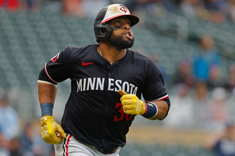 Jun 20, 2024; Minneapolis, Minnesota, USA; Minnesota Twins first baseman Carlos Santana (30) watches his solo home run against the Tampa Bay Rays in the ninth inning at Target Field. Mandatory Credit: Bruce Kluckhohn-USA TODAY Sports