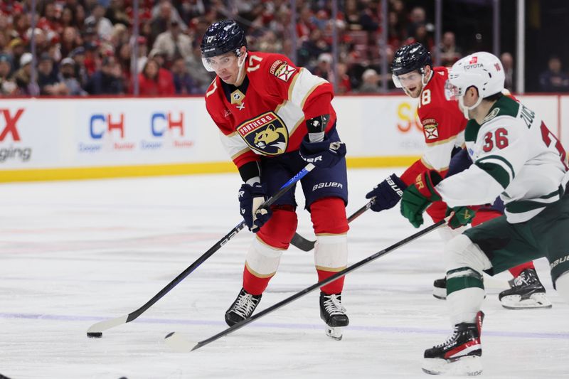 Jan 19, 2024; Sunrise, Florida, USA; Florida Panthers center Evan Rodrigues (17) passes the puck against the Minnesota Wild during the second period at Amerant Bank Arena. Mandatory Credit: Sam Navarro-USA TODAY Sports