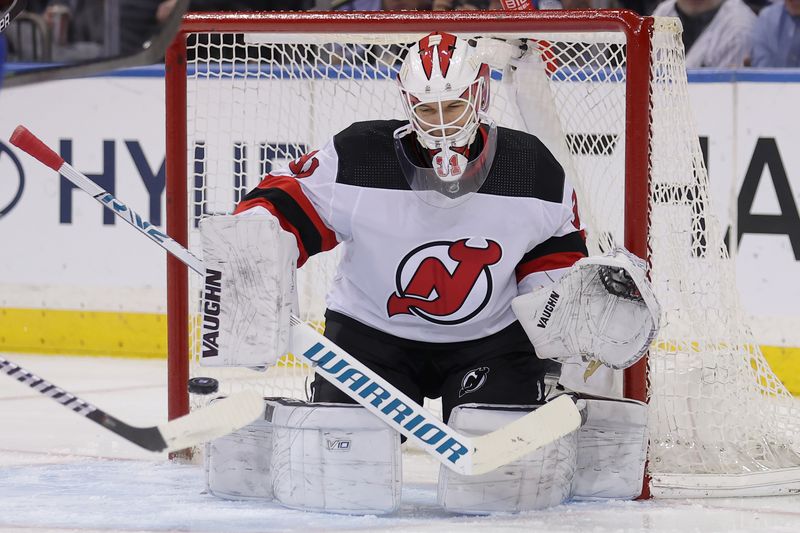 Mar 11, 2024; New York, New York, USA; New Jersey Devils goaltender Kaapo Kahkonen (31) makes a save against the New York Rangers during the first period at Madison Square Garden. Mandatory Credit: Brad Penner-USA TODAY Sports