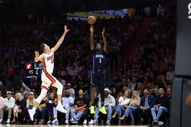 MIAMI, FLORIDA - OCTOBER 23: Kentavious Caldwell-Pope #3 of the Orlando Magic shoots over Duncan Robinson #55 of the Miami Heat during the second half at Kaseya Center on October 23, 2024 in Miami, Florida. NOTE TO USER: User expressly acknowledges and agrees that, by downloading and or using this photograph, User is consenting to the terms and conditions of the Getty Images License Agreement. (Photo by Carmen Mandato/Getty Images)