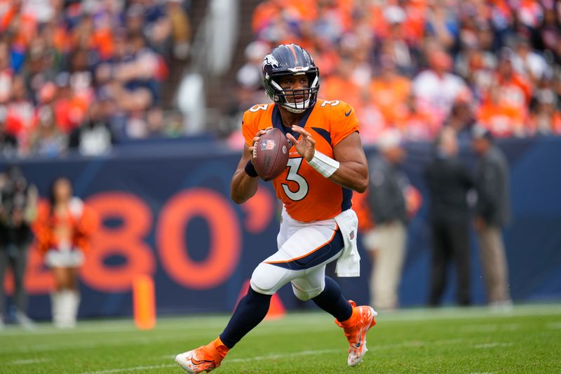 Denver Broncos quarterback Russell Wilson (3) rolls out against the Las Vegas Raiders during an NFL football game Sunday, Sept. 10, 2023, in Denver. (AP Photo/Jack Dempsey)