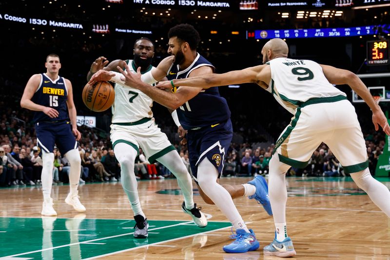 BOSTON, MA - JANUARY 19: Jamal Murray #27 of the Denver Nuggets loses the ball going between Derrick White #9 of the Boston Celtics and Jaylen Brown #7 during the second quarter at TD Garden on January 19, 2024 in Boston, Massachusetts. NOTE TO USER: User expressly acknowledges and agrees that, by downloading and/or using this Photograph, user is consenting to the terms and conditions of the Getty Images License Agreement. (Photo By Winslow Townson/Getty Images)