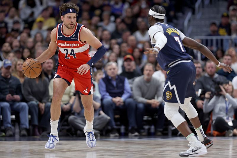 DENVER, COLORADO - FEBRUARY 22: Corey Kispert #24 of the Washington Wizards brings the ball down the court against Kentavious Caldwell-Pope #5 of the Denver Nuggets in the first quarter at Ball Arena on February 22, 2024 in Denver, Colorado. NOTE TO USER: User expressly acknowledges and agrees that, by downloading and or using this photograph, User is consenting to the terms and conditions of the Getty Images License Agreement. (Photo by Matthew Stockman/Getty Images)