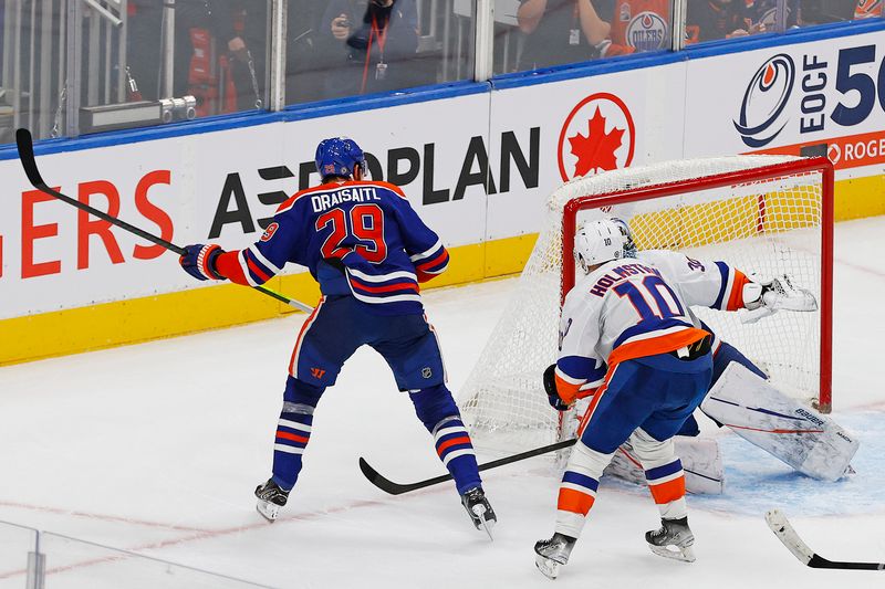 Nov 12, 2024; Edmonton, Alberta, CAN; Edmonton Oilers forward Leon Draisaitl (29) scores the winning goal during overtime against the New York Islanders. The assist by forward Connor McDavid (97) was his 999th point in the NHL at Rogers Place. Mandatory Credit: Perry Nelson-Imagn Images