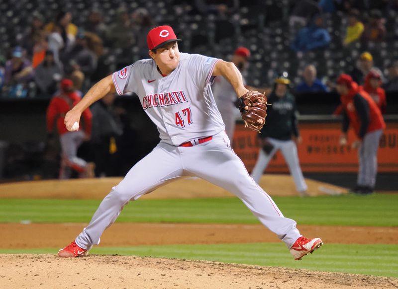 Apr 28, 2023; Oakland, California, USA; Cincinnati Reds relief pitcher Derek Law (47) pitches the ball against the Oakland Athletics during the seventh inning at Oakland Coliseum. Mandatory Credit: Kelley L Cox-USA TODAY Sports