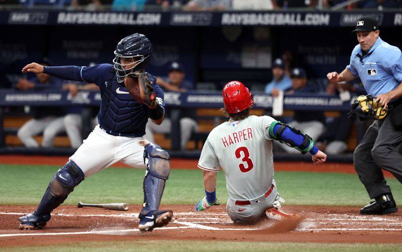 Jul 5, 2023; St. Petersburg, Florida, USA; Philadelphia Phillies designated hitter Bryce Harper (3) scores during the third inning as Tampa Bay Rays catcher Francisco Mejia (21) attempts to tag him out at Tropicana Field. Mandatory Credit: Kim Klement-USA TODAY Sports