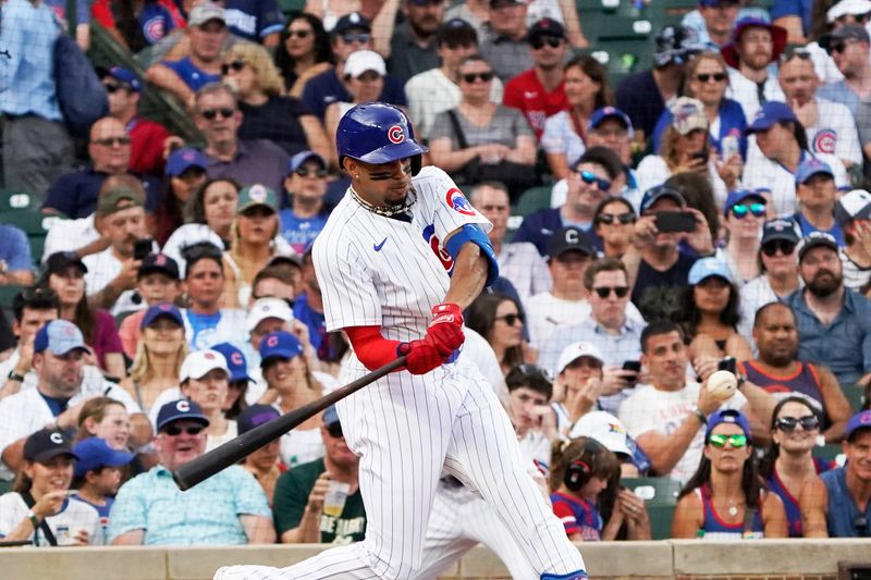 Jul 15, 2023; Chicago, Illinois, USA; Chicago Cubs second baseman Christopher Morel (5) hits a one run single against the Boston Red Sox during the seventh inning at Wrigley Field. Mandatory Credit: David Banks-USA TODAY Sports