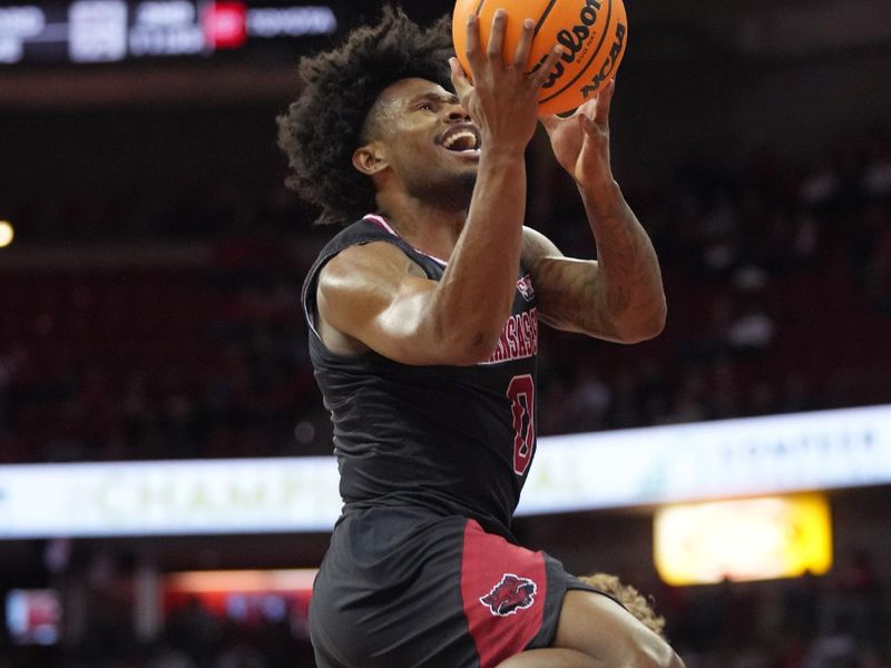 Nov 6, 2023; Madison, Wisconsin, USA;  Arkansas State Red Wolves guard Caleb Fields (0) shoots the ball under coverage by Wisconsin Badgers guard Max Klesmit (11) during the first half at the Kohl Center. Mandatory Credit: Kayla Wolf-USA TODAY Sports