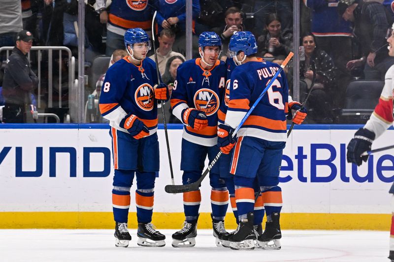 Oct 26, 2024; Elmont, New York, USA;  New York Islanders defenseman Noah Dobson (8) and New York Islanders defenseman Ryan Pulock (6) celebrate the goal by New York Islanders center Brock Nelson (29) against the Florida Panthers during the first period at UBS Arena. Mandatory Credit: Dennis Schneidler-Imagn Images