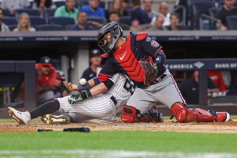 Aug 23, 2023; Bronx, New York, USA; New York Yankees center fielder Harrison Bader (22) scores a run on an RBI by center fielder Everson Pereira (not pictured) as Washington Nationals catcher Keibert Ruiz (20) can not handle the throw during the second inning at Yankee Stadium. Mandatory Credit: Vincent Carchietta-USA TODAY Sports