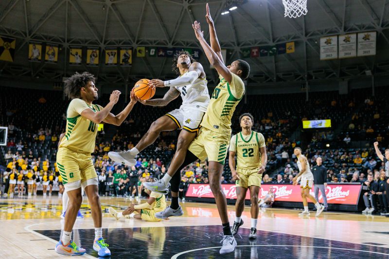 Jan 14, 2025; Wichita, Kansas, USA; Wichita State Shockers guard Justin Hill (11) collides with Charlotte 49ers forward Robert Braswell IV (20) during the second half at Charles Koch Arena. Mandatory Credit: William Purnell-Imagn Images