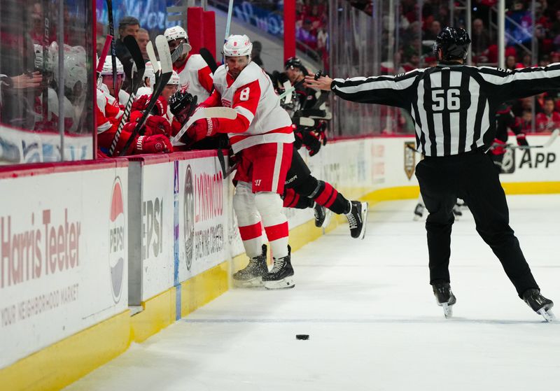 Jan 19, 2024; Raleigh, North Carolina, USA;  Detroit Red Wings defenseman Ben Chiarot (8) checks Carolina Hurricanes right wing Andrei Svechnikov (37) during the first period at PNC Arena. Mandatory Credit: James Guillory-USA TODAY Sports