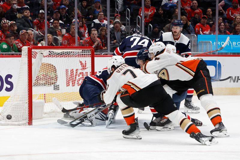 Jan 16, 2024; Washington, District of Columbia, USA; Anaheim Ducks right wing Frank Vatrano (77) and Ducks defenseman Ilya Lyubushkin (46) reach for the puck in front of Washington Capitals goaltender Darcy Kuemper (35) in the second period at Capital One Arena. Mandatory Credit: Geoff Burke-USA TODAY Sports