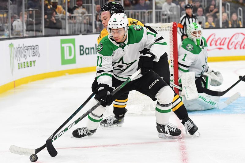 Oct 24, 2024; Boston, Massachusetts, USA;  Dallas Stars center Logan Stankoven (11) controls the puck from Boston Bruins center Morgan Geekie (39) during the third period at TD Garden. Mandatory Credit: Bob DeChiara-Imagn Images