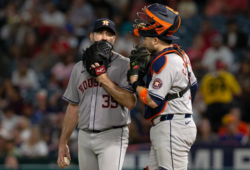 Sep 14, 2024; Anaheim, California, USA; Houston Astros pitcher Justin Verlander (35) talks to catcher Victor Caratini (17) during the 5th inning against the Los Angeles Angels at Angel Stadium. Mandatory Credit: Jason Parkhurst-Imagn Images