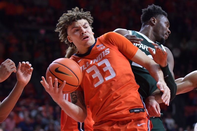 Jan 11, 2024; Champaign, Illinois, USA;  Illinois Fighting Illini forward Coleman Hawkins (33) tries to control the ball under the basket during the second half against the Michigan State Spartans at State Farm Center. Mandatory Credit: Ron Johnson-USA TODAY Sports