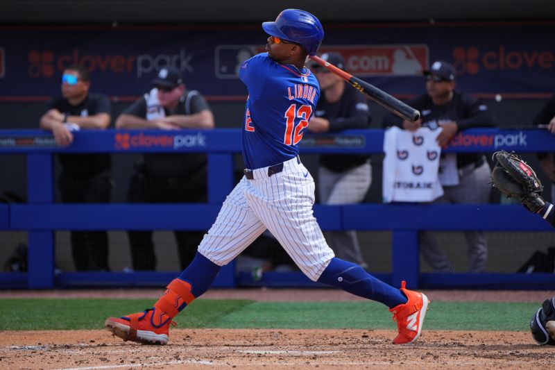 Mar 5, 2024; Port St. Lucie, Florida, USA;  New York Mets shortstop Francisco Lindor (12) hits a double to right field in the third inning against the New York Yankees at Clover Park. Mandatory Credit: Jim Rassol-USA TODAY Sports