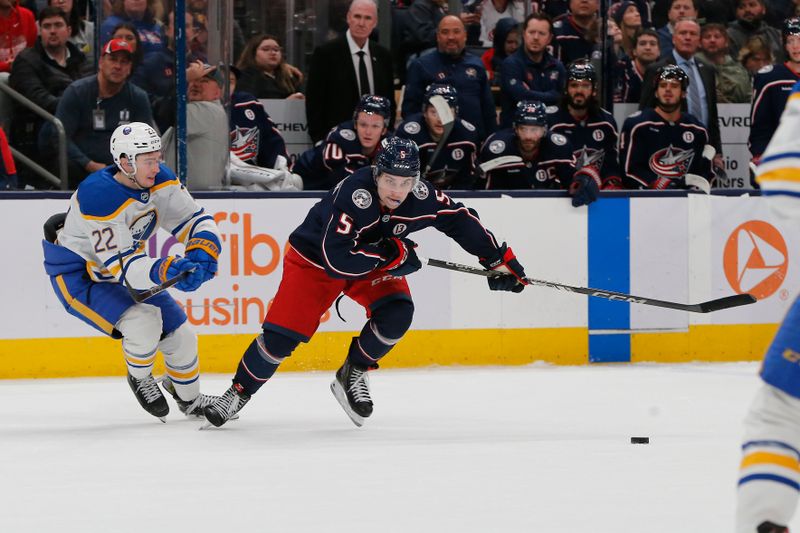 Apr 10, 2025; Columbus, Ohio, USA;  Columbus Blue Jackets defenseman Denton Mateychuk (5) carries the puck away from Buffalo Sabres right wing Jack Quinn (22) during the second period at Nationwide Arena. Mandatory Credit: Russell LaBounty-Imagn Images