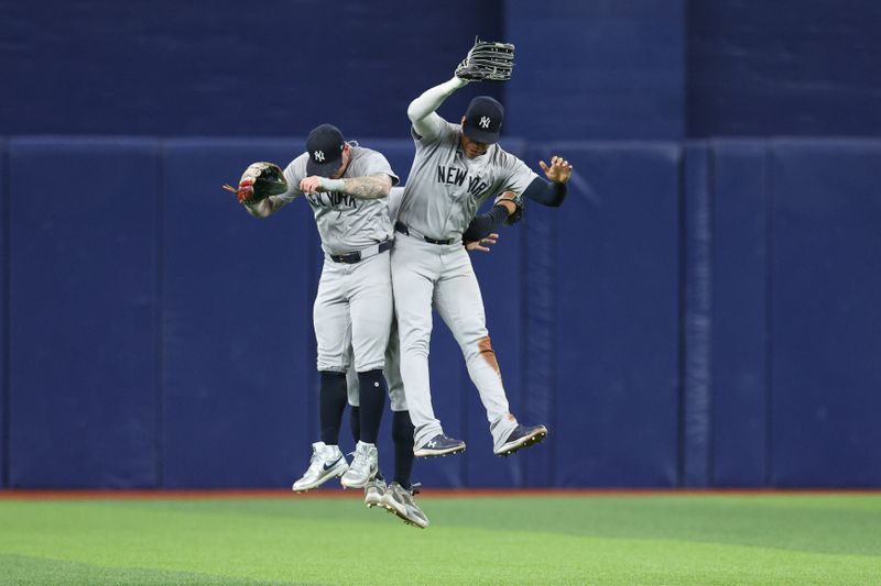 Jul 10, 2024; St. Petersburg, Florida, USA; New York Yankees outfielder Alex Verdugo (24) outfielder Trent Grisham (12) and outfielder Juan Soto (22) celebrate after beating the Tampa Bay Rays at Tropicana Field. Mandatory Credit: Nathan Ray Seebeck-USA TODAY Sports