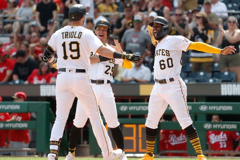 Aug 13, 2023; Pittsburgh, Pennsylvania, USA; Pittsburgh Pirates catcher Endy Rodriguez (25) and shortstop Liover Peguero (60) congratulate pinch hitter Jared Triolo (19) at home plate after Triolo hit a three run home run to record his first major league home run against the Cincinnati Reds during the seventh inning at PNC Park. Mandatory Credit: Charles LeClaire-USA TODAY Sports