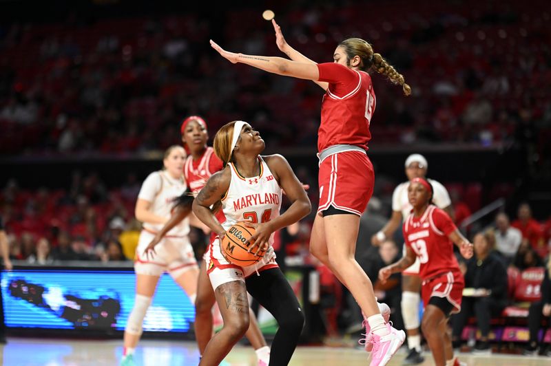 Feb 29, 2024; College Park, Maryland, USA;  Maryland Terrapins guard Bri McDaniel (24) looks to to shoot as Wisconsin Badgers guard Sania Copeland (15) leaps to defend during the first half at Xfinity Center. Mandatory Credit: Tommy Gilligan-USA TODAY Sports