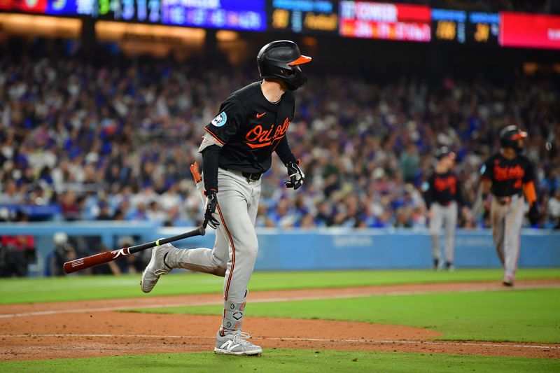 Aug 29, 2024; Los Angeles, California, USA; Baltimore Orioles left fielder Colton Cowser (17) hits a three run home run against the Los Angeles Dodgers during the fifth inning at Dodger Stadium. Mandatory Credit: Gary A. Vasquez-USA TODAY Sports