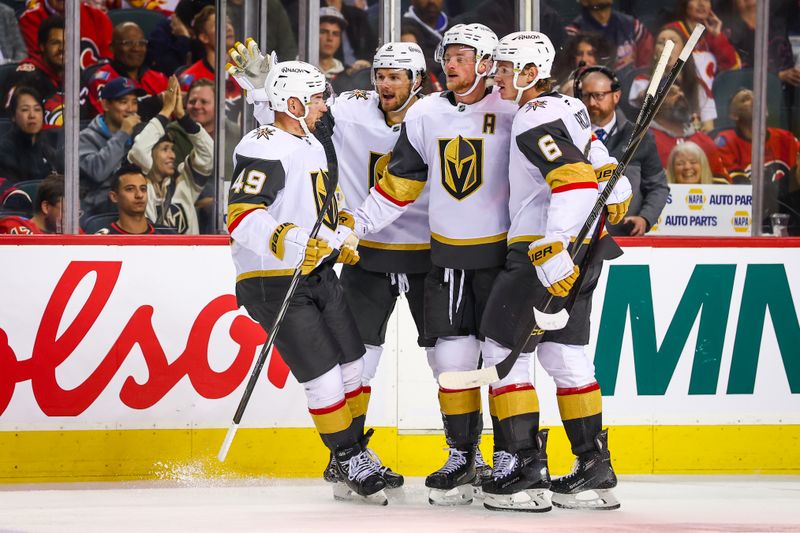 Oct 14, 2025; Calgary, Alberta, CAN; Vegas Golden Knights center Jack Eichel (9) celebrates his goal with teammates against the Calgary Flames during the third period at Scotiabank Saddledome. Mandatory Credit: Sergei Belski-Imagn Images