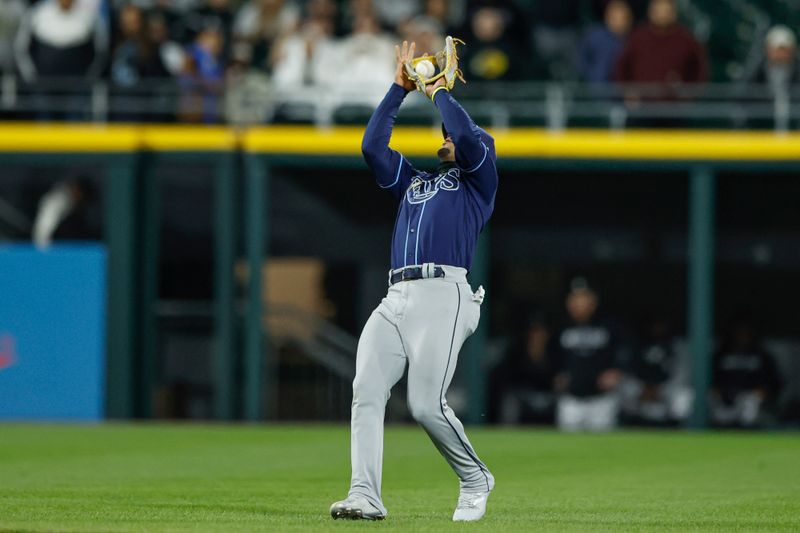 Apr 28, 2023; Chicago, Illinois, USA; Tampa Bay Rays shortstop Wander Franco (5) catches a fly ball hit by Chicago White Sox center fielder Luis Robert Jr. (not pictured) for a final out during the ninth inning at Guaranteed Rate Field. Mandatory Credit: Kamil Krzaczynski-USA TODAY Sports