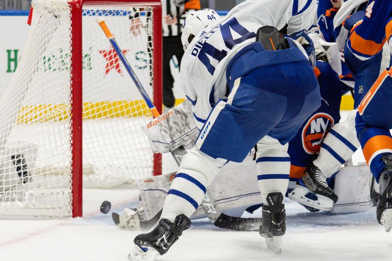 Dec 11, 2023; Elmont, New York, USA; Toronto Maple Leafs defenseman Morgan Rielly (44) scores the game tying goal against the New York Islanders during the third period at UBS Arena. Mandatory Credit: Thomas Salus-USA TODAY Sports