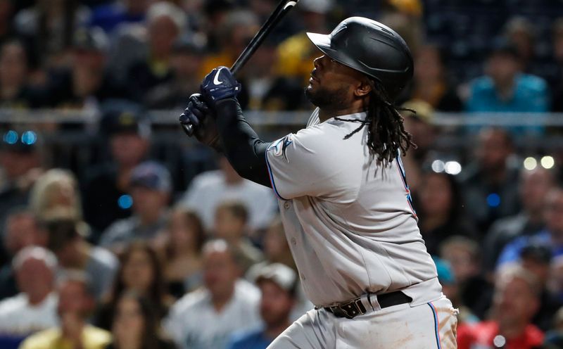 Sep 30, 2023; Pittsburgh, Pennsylvania, USA; Miami Marlins first baseman Josh Bell (9) drives in a run with a sacrifice fly against the Pittsburgh Pirates during the sixth inning at PNC Park. Mandatory Credit: Charles LeClaire-USA TODAY Sports