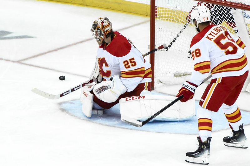 Feb 8, 2024; Newark, New Jersey, USA; Calgary Flames goaltender Jacob Markstrom (25) makes a save against the New Jersey Devils during the third period at Prudential Center. Mandatory Credit: John Jones-USA TODAY Sports