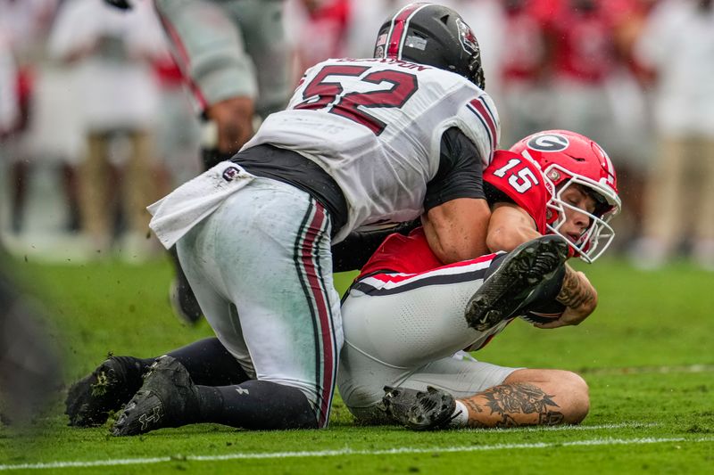 Sep 16, 2023; Athens, Georgia, USA; Georgia Bulldogs quarterback Carson Beck (15) is hit late after sliding by South Carolina Gamecocks linebacker Stone Blanton (52) during the first half at Sanford Stadium. Mandatory Credit: Dale Zanine-USA TODAY Sports