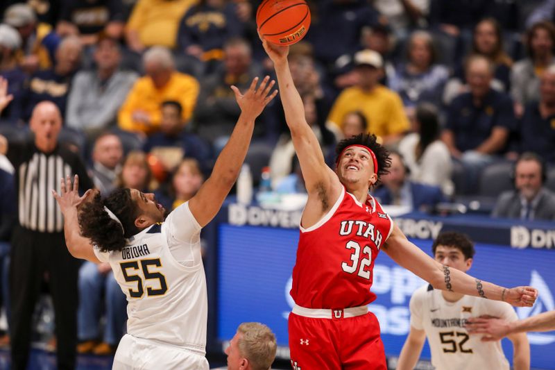 Feb 18, 2026; Morgantown, West Virginia, USA; Utah Utes forward James Okonkwo (32) and West Virginia Mountaineers center Harlan Obioha (55) jump for the tip at Hope Coliseum. Mandatory Credit: Ben Queen-Imagn Images