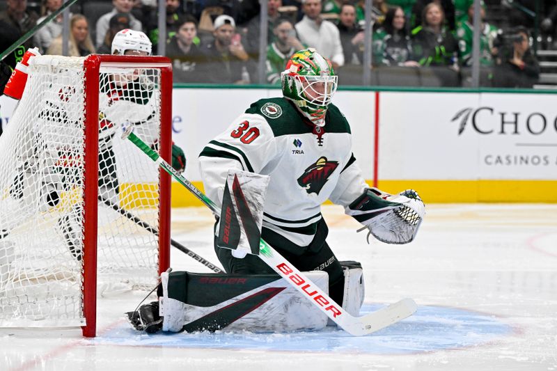 Jan 10, 2024; Dallas, Texas, USA; Minnesota Wild goaltender Jesper Wallstedt (30) faces the Dallas Stars attack during the second period at the American Airlines Center. Mandatory Credit: Jerome Miron-USA TODAY Sports