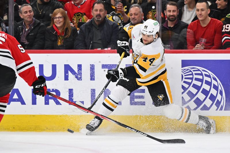 Feb 15, 2024; Chicago, Illinois, USA; Pittsburgh Penguins forward Jonathan Gruden (44) attempts a shot on goal in the second period against the Chicago Blackhawks at United Center. Mandatory Credit: Jamie Sabau-USA TODAY Sports