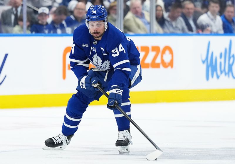 May 7, 2025; Toronto, Ontario, CAN; Toronto Maple Leafs center Auston Matthews (34) skates with the puck against the Florida Panthers during the first period in game two of the second round of the 2025 Stanley Cup Playoffs at Scotiabank Arena. Mandatory Credit: Nick Turchiaro-Imagn Images