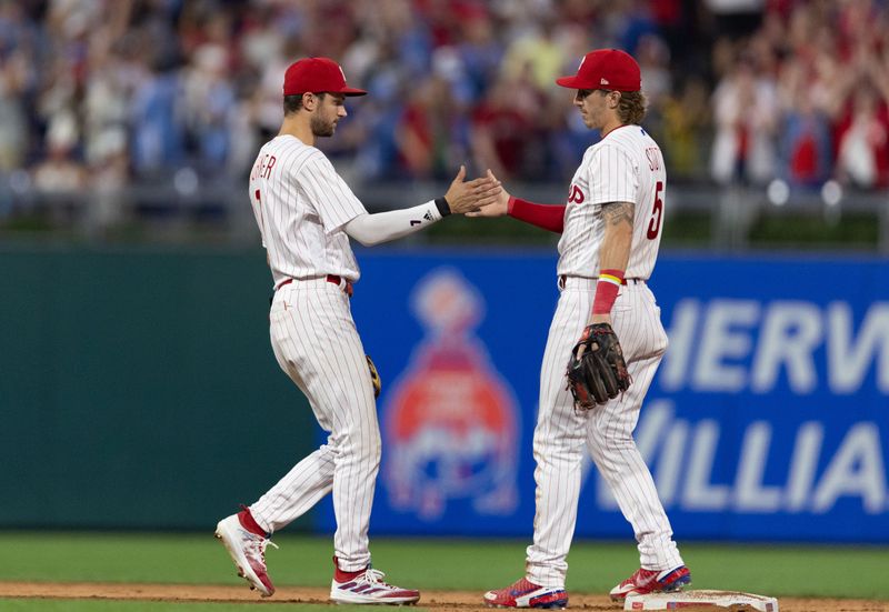 Aug 5, 2023; Philadelphia, Pennsylvania, USA; Philadelphia Phillies shortstop Trea Turner (7) and second baseman Bryson Stott (5) slap hands after a victory against the Kansas City Royals at Citizens Bank Park. Mandatory Credit: Bill Streicher-USA TODAY Sports