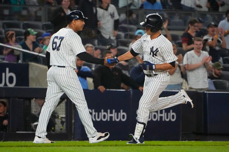 Jun 22, 2023; Bronx, New York, USA; New York Yankees third base coach Luis Rojas (67) congratulates New York Yankees shortstop Isiah Kiner-Falefa (12) for hitting a two run home run against the Seattle Mariners during the ninth inning at Yankee Stadium. Mandatory Credit: Gregory Fisher-USA TODAY Sports