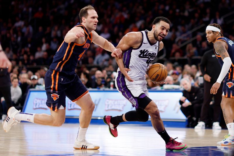 NEW YORK, NEW YORK - APRIL 04: Trey Lyles #41 of the Sacramento Kings dribbles against Bojan Bogdanovic #44 of the New York Knicks during the second half at Madison Square Garden on April 04, 2024 in New York City. The Knicks won 120-109. NOTE TO USER: User expressly acknowledges and agrees that, by downloading and/or using this Photograph, user is consenting to the terms and conditions of the Getty Images License Agreement. (Photo by Sarah Stier/Getty Images)