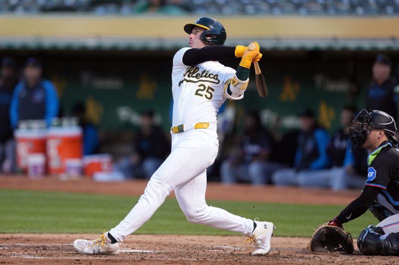 May 3, 2024; Oakland, California, USA; Oakland Athletics designated hitter Brent Rooker (25) hits a home run against the Miami Marlins during the fourth inning at Oakland-Alameda County Coliseum. Mandatory Credit: Darren Yamashita-USA TODAY Sports