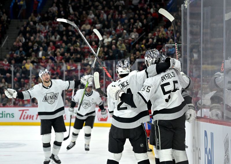 Dec 7, 2023; Montreal, Quebec, CAN;Los Angeles Kings forward Quinton Byfield (55) celebrates with teammates after scoring a goal against the Montreal Canadiens during the first period at the Bell Centre. Mandatory Credit: Eric Bolte-USA TODAY Sports