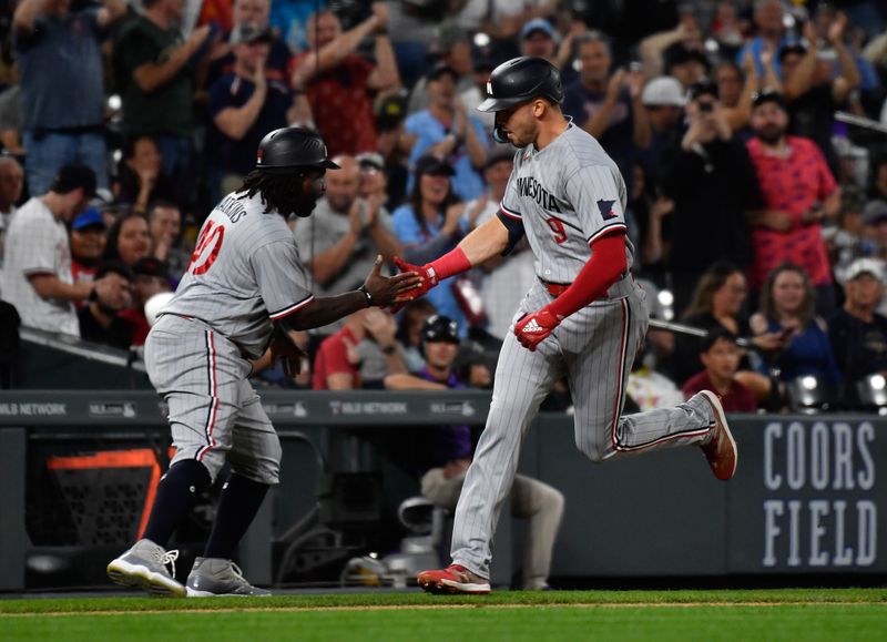 Sep 30, 2023; Denver, Colorado, USA; Minnesota Twins third base coach/outfield coach Tommy Watkins (40) congratulates Minnesota Twins designated hitter Trevor Larnach (9) after his grand slam against the Colorado Rockies in the third inning at Coors Field. Mandatory Credit: John Leyba-USA TODAY Sports